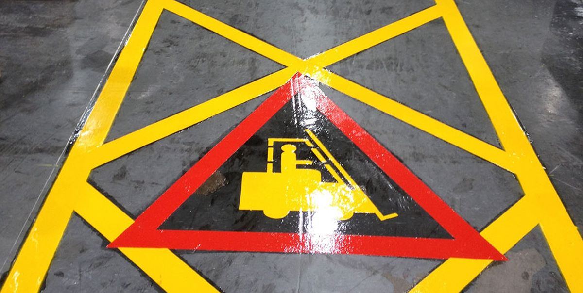 On-Line Roadmarking crew applying preformed thermoplastic markings by hand