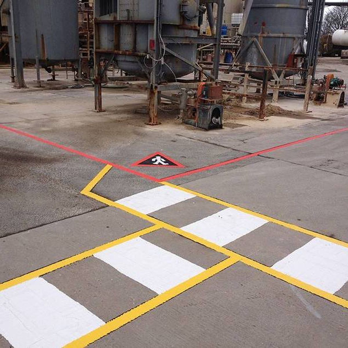 Yellow and white pedestrian crossing and traffic lanes inside a distribution warehouse