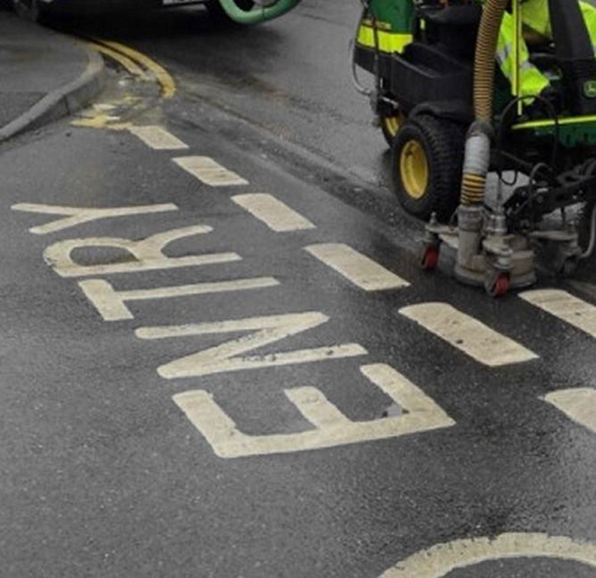 Line removal machine stripping redundant KEEP CLEAR markings from a road surface